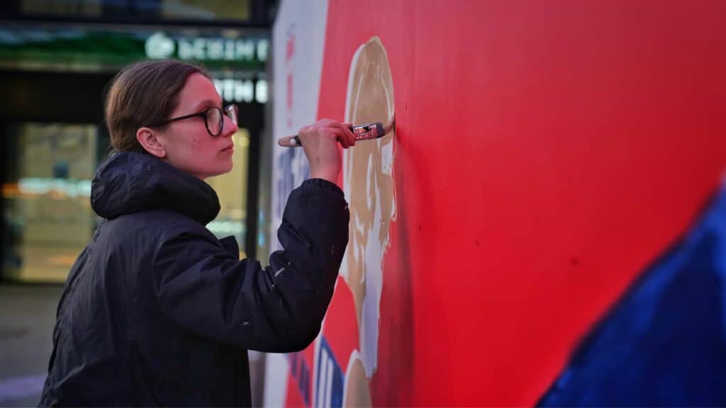 Tessa Dorotich painting a Mural for Melbourne Football Club
